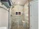 A modern shower with tile walls, a shower head, and glass doors at 1034 Se 65Th Cir, Ocala, FL 34472