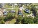 An aerial view of a neighborhood featuring a home with a screened-in pool and fenced yard at 10910 Sw 47Th Ct, Ocala, FL 34476