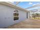 Back exterior of house with a patio, deck, and white framed windows with a view of the fenced backyard at 10910 Sw 47Th Ct, Ocala, FL 34476