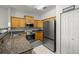 A kitchen featuring wooden cabinets, granite countertops, and stainless steel appliances at 10910 Sw 47Th Ct, Ocala, FL 34476