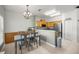 A kitchen area with modern appliances, wooden cabinets, and a connecting dining area at 10910 Sw 47Th Ct, Ocala, FL 34476