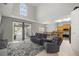 A living room featuring neutral walls, sliding glass doors to the lanai, and view of the kitchen at 10910 Sw 47Th Ct, Ocala, FL 34476