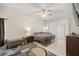 This main bedroom features tile flooring, a ceiling fan, and a sliding glass door for ample natural light at 10910 Sw 47Th Ct, Ocala, FL 34476