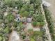 Aerial view of property featuring multiple outbuildings, pool, and natural surroundings at 1370 Nw 120Th Ave, Ocala, FL 34482