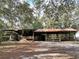 Large open barn structure featuring wooden beams and a red roof, surrounded by natural terrain at 1370 Nw 120Th Ave, Ocala, FL 34482