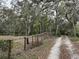 Gravel driveway leading to property with wooded surroundings at 1370 Nw 120Th Ave, Ocala, FL 34482