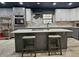 Kitchen island with seating and modern countertops, complemented by stylish cabinetry and a view of the backyard at 1370 Nw 120Th Ave, Ocala, FL 34482