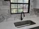 Close-up of the kitchen sink area with modern faucet and view of a horse grazing outside the window at 1370 Nw 120Th Ave, Ocala, FL 34482