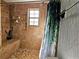 Shower featuring tiled walls, tiled bench, and greenery at 1370 Nw 120Th Ave, Ocala, FL 34482