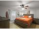 Comfortable bedroom with a ceiling fan, complemented by a wood dresser, nightstand, and a queen sized bed at 33827 Silver Pine Dr, Leesburg, FL 34788