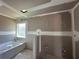 Under-construction bathroom highlighting the window, tub, and plumbing at 4397 Sw 90Th Pl, Ocala, FL 34476