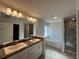 Bathroom featuring double sinks, a large mirror, a separate soaking tub, and a glass enclosed shower at 4397 Sw 90Th Pl, Ocala, FL 34476