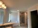 Bright bathroom featuring a soaking tub, tiled shower, and access to the closet for convenience at 4397 Sw 90Th Pl, Ocala, FL 34476