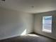 Bright bedroom featuring neutral walls, plush carpeting, and a window offering natural light at 4397 Sw 90Th Pl, Ocala, FL 34476