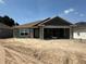New construction home featuring concrete walls, open garage, and a clean, modern design at 4397 Sw 90Th Pl, Ocala, FL 34476