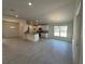 Open-concept kitchen featuring white cabinets, granite countertops, recessed lights, and ceramic tile floors at 4397 Sw 90Th Pl, Ocala, FL 34476