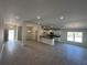 Open-concept kitchen featuring white cabinets, granite countertops, recessed lights, and ceramic tile floors at 4397 Sw 90Th Pl, Ocala, FL 34476