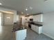 Open-concept kitchen with granite countertops, stainless appliances and white cabinetry at 4397 Sw 90Th Pl, Ocala, FL 34476