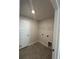 Bright laundry room featuring ceramic tile flooring, white door and wall-mounted wire shelving at 4397 Sw 90Th Pl, Ocala, FL 34476