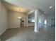 Spacious living room featuring ceramic tile flooring, recessed lighting and a dining area off the kitchen at 4397 Sw 90Th Pl, Ocala, FL 34476