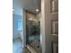 Newly constructed shower with glass door, tile surround, and a view into the bathroom at 4397 Sw 90Th Pl, Ocala, FL 34476