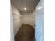 Carpeted walk-in closet with wire shelving, and a light for added convenience at 4397 Sw 90Th Pl, Ocala, FL 34476