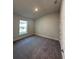 Neutral bedroom with a window, carpet, and a white door at 4413 Sw 90Th Pl, Ocala, FL 34476