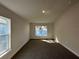 This bedroom has neutral walls, carpet, and natural light coming in from the window at 4413 Sw 90Th Pl, Ocala, FL 34476