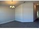 Bright dining room features modern chandelier, neutral walls, and plush carpet, perfect for Gathering meals at 4413 Sw 90Th Pl, Ocala, FL 34476