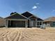 Image of an unfinished home with a large two car garage and visible construction materials at 4413 Sw 90Th Pl, Ocala, FL 34476