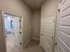 Hallway features neutral walls, bright white doors, and opens to a kitchen area with light colored countertops at 4413 Sw 90Th Pl, Ocala, FL 34476