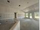 Unfinished living room features drywall, large window views of the exterior at 4413 Sw 90Th Pl, Ocala, FL 34476