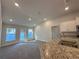 This open living area offers recessed lighting, large windows, and is adjacent to the kitchen at 4413 Sw 90Th Pl, Ocala, FL 34476