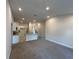 Open living room with a view of the kitchen with granite countertop bar and stainless steel sink at 4413 Sw 90Th Pl, Ocala, FL 34476