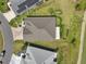 Aerial view showcasing the home's roof, yard, and driveway at 5766 Henry Loop, The Villages, FL 32163