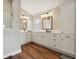 Well-lit bathroom with double sink vanity, quartz countertops, and modern fixtures at 5766 Henry Loop, The Villages, FL 32163