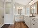 This bathroom features double sinks, sleek countertops, lots of storage and a glass-enclosed shower at 5766 Henry Loop, The Villages, FL 32163