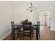 Dining area with modern lighting, dark wood table and chairs, and seamless flooring at 5766 Henry Loop, The Villages, FL 32163