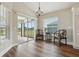 Bright dining area features wood-look flooring, natural light, and stylish light fixture at 5766 Henry Loop, The Villages, FL 32163