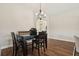 Cozy dining room with wood floors, an elegant chandelier, and stylish table setting at 5766 Henry Loop, The Villages, FL 32163