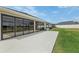 Exterior view of the house featuring an enclosed lanai and landscaping at 5766 Henry Loop, The Villages, FL 32163