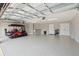 The garage with painted walls and epoxy flooring includes a golf cart at 5766 Henry Loop, The Villages, FL 32163