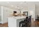 Spacious kitchen features white cabinets, an island with seating, and modern appliances at 5766 Henry Loop, The Villages, FL 32163