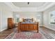 Large main bedroom features a tray ceiling, ceiling fan, wood floors and bright windows at 5766 Henry Loop, The Villages, FL 32163