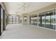 Large enclosed patio with three ceiling fans and panoramic view of the backyard at 5766 Henry Loop, The Villages, FL 32163