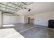 View of garage with overhead door, window, storage room and coated floor at 7014 Elaine Ct, The Villages, FL 34762