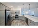 Well-lit kitchen features stainless steel appliances, gray cabinets, and modern countertops at 7014 Elaine Ct, The Villages, FL 34762