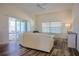 Bright living room with neutral decor, wood floors and sliding glass doors to screened porch at 7014 Elaine Ct, The Villages, FL 34762