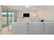 Comfortable living area featuring a plush gray sectional sofa, media center, and access to the outdoor space at 8491 Sw 52Nd Lane Rd, Ocala, FL 34481