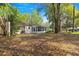 Spacious backyard with mature trees providing ample shade, a screen room and wooded views at 8700 Sw 98Th Street Rd # E, Ocala, FL 34481